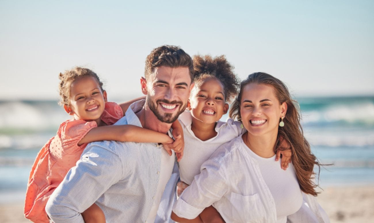 Family smiling on beach